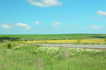 Country road over blue sky background