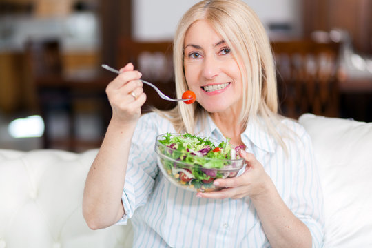 Mature woman eating a healthy salad