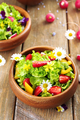 Light organic salad with flowers, close up