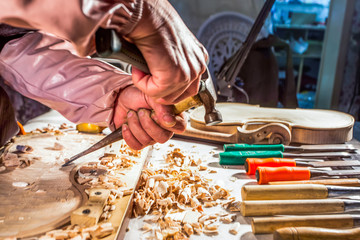 carpenter engraving violin with tools