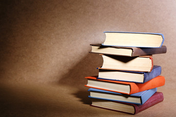 Old books on shelf, close-up, on wooden background