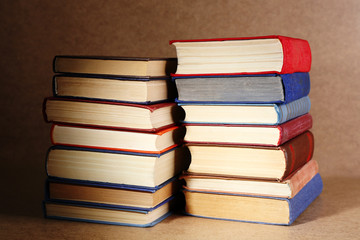 Old books on shelf, close-up, on wooden background
