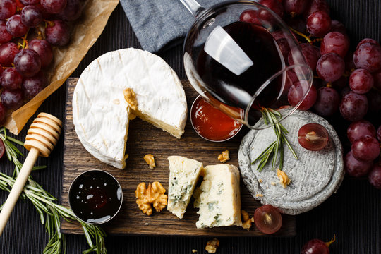 Cheese plate served with wine, jam and honey