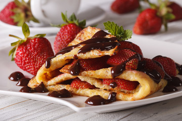Delicious crepes with fresh strawberries and chocolate