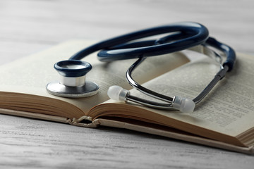 Stethoscope on open book close up