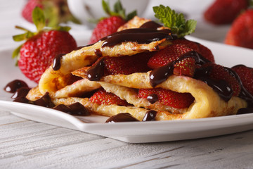Beautiful crepes with fresh strawberries close-up
