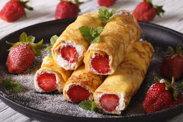 crepes with strawberries and cream cheese close-up. Horizontal
