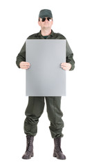 Man in workwear stands with paper.