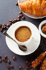Fresh croissants  and cup of coffee on a table