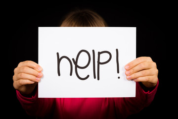 Child holding Help sign