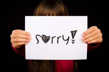 Child holding Sorry sign