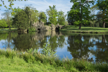 Fototapeta na wymiar A lake and cave in a Surrey park.