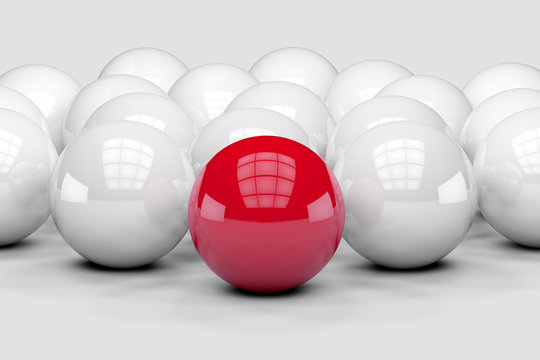 Many white balls among which the red stands out. 3D render image © marinv