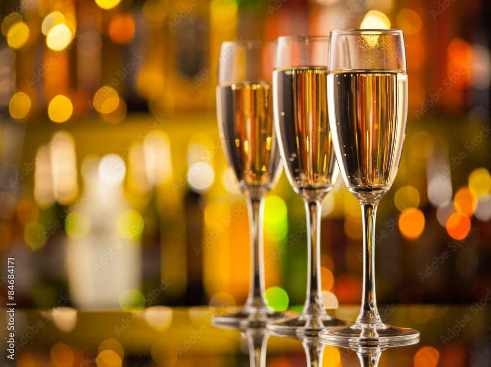 Wall mural glasses of champagne with blur background