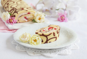 Homemade sponge roll with chocolate patterns, strawberries