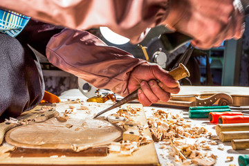 carpenter engraving violin with tools