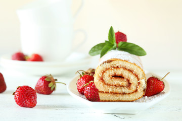 Fresh strawberries cake on plate on white wooden background