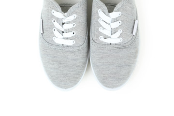 Pair of grey shoes on white background