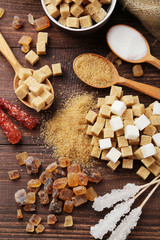 Various kinds of sugar on brown wooden background