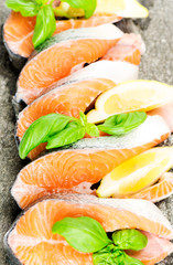 Salmon on stone with basil and lemon