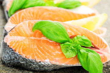 Salmon on stone with basil and lemon macro