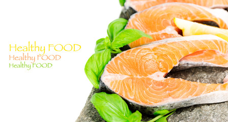 Salmon on stone with basil and lemon isolated, copy space