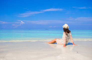 Fototapeta na wymiar Young happy woman enjoy summer vacation on white sandy beach