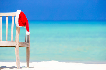 Red santa hat on beach chair at tropical vacation