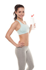 Sporty girl drinking water from a bottle after a workout, fitness training, isolated on white background