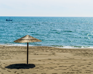 Wooden parasols on sandy beach