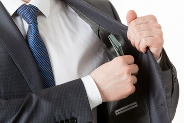 Businessman holding putting dollars in a pocket