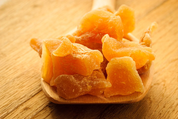 Closeup candied ginger on wooden spoon