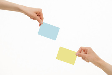 Human hands holding colorful paper cards