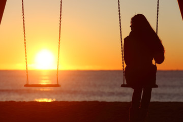 Fototapeta Single woman alone swinging on the beach obraz