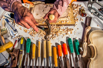 carpenter engraving violin with tools