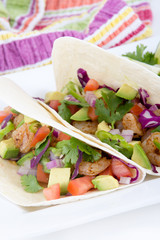High resolution two spicy shrimp taco with avocado, tomato and red onion cilantro
