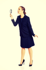 Businesswoman with magnifying glass.