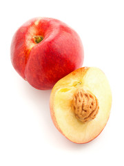 White nectarine whole and sliced over white