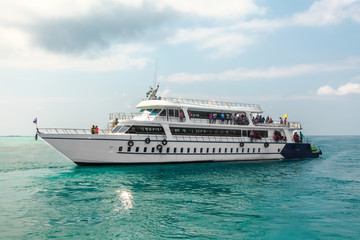 Fototapeta premium Big white passengers ship on blue tropical sea