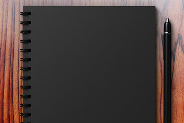 black diary on a wooden table