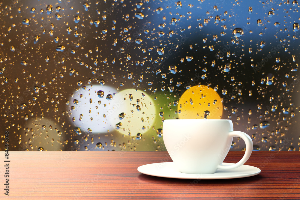 Wall mural cup of coffee on the background of the window with raindrops