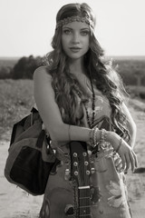 Attractive girl travelling with her guitar