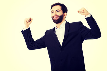 Businessman making fists in a winner gesture.