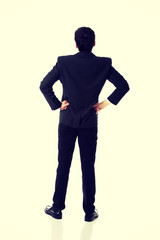 Businessman with hands on hips.