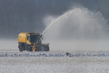 Snowplow removing snow at an airfield