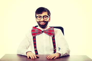 Young old fashioned man sitting by a desk.