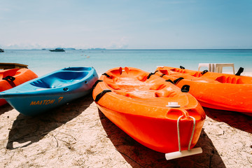canoe on beach with blue sky - soft focus with film filter