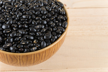 black beans on wood background
