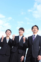 Asian businessman and businesswoman looking up at the sky