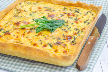 Ricotta spinach pie on the wooden table, closeup